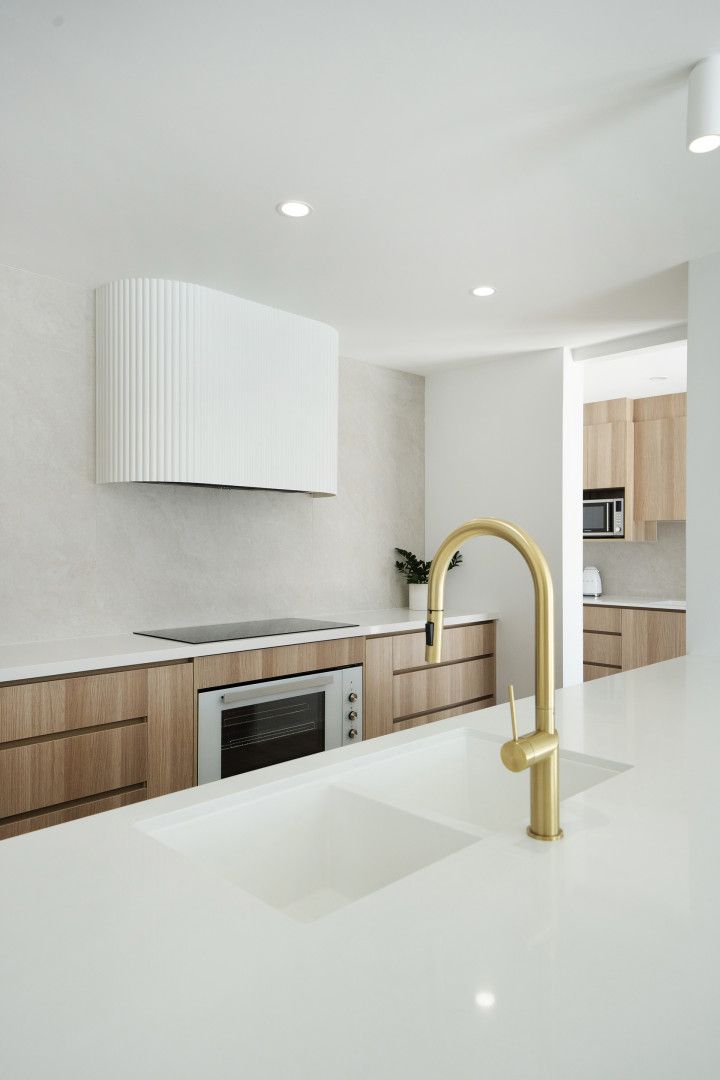 Modern White Kitchen With Gold Faucet, Island Countertop — Reynolds Built In Moffat Beach, QLD