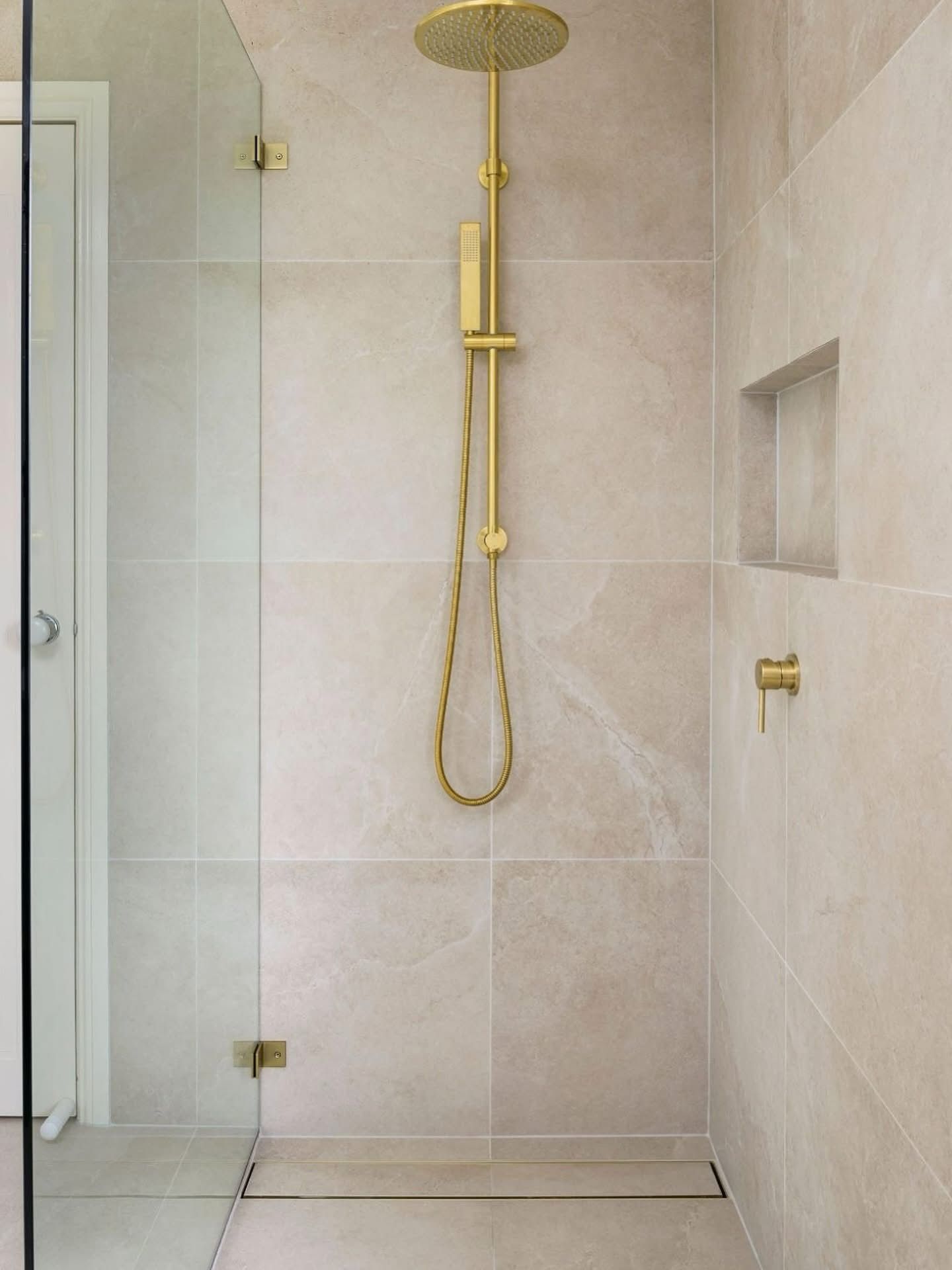 A Shower With Marble-like White and Beige Tiles — Reynolds Built In Moffat Beach, QLD