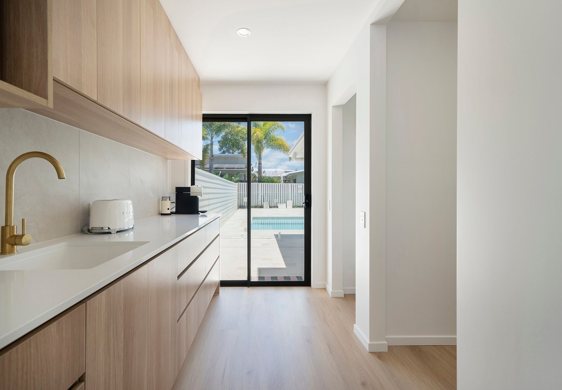 Modern White House With a Turquoise Pool Under a Bright Blue Sky — Reynolds Built In Maroochydore, QLD