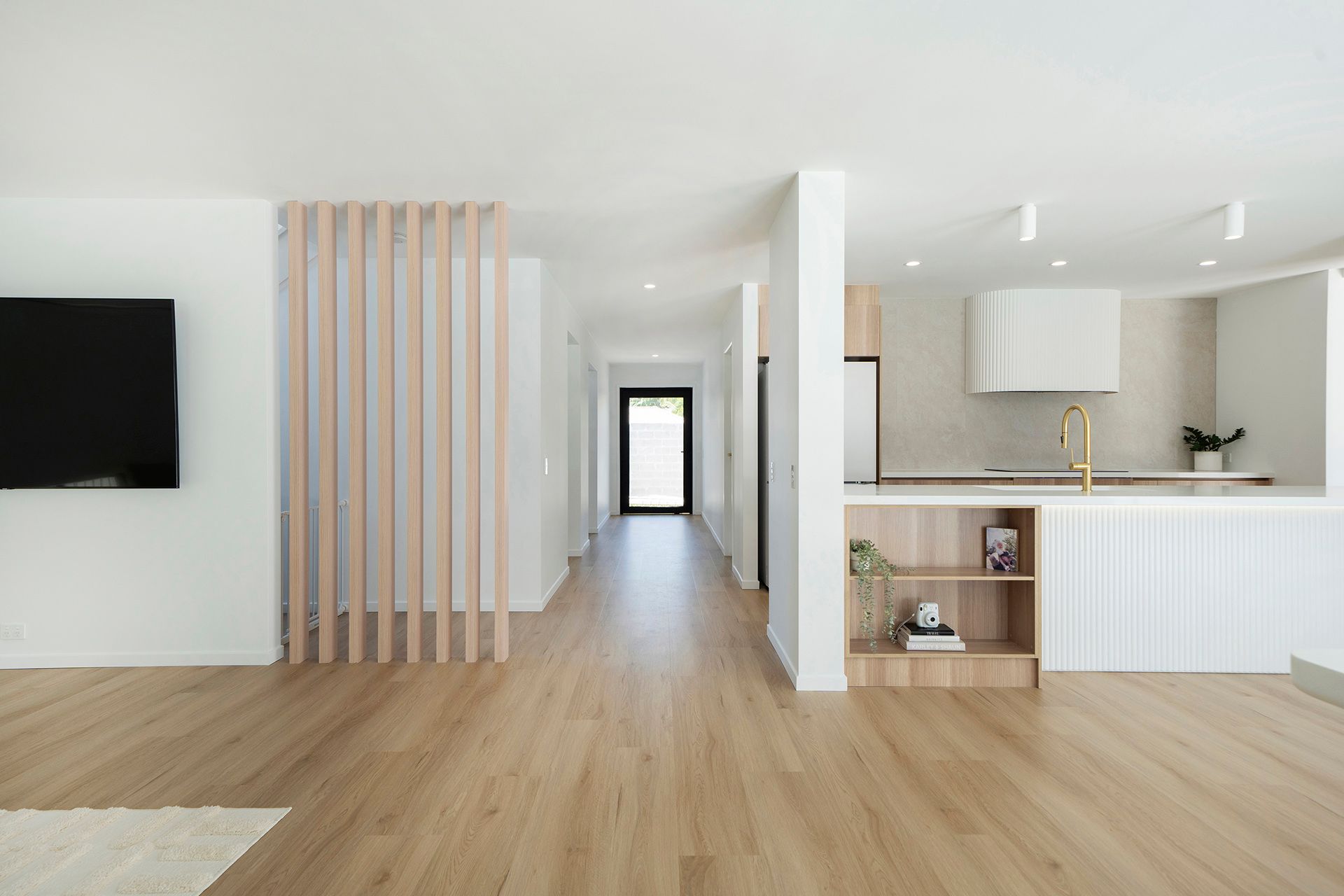 Modern Open-plan Living Room With Wood Floors, Kitchen, and Hallway — Reynolds Built In Alexandra Headlands, QLD