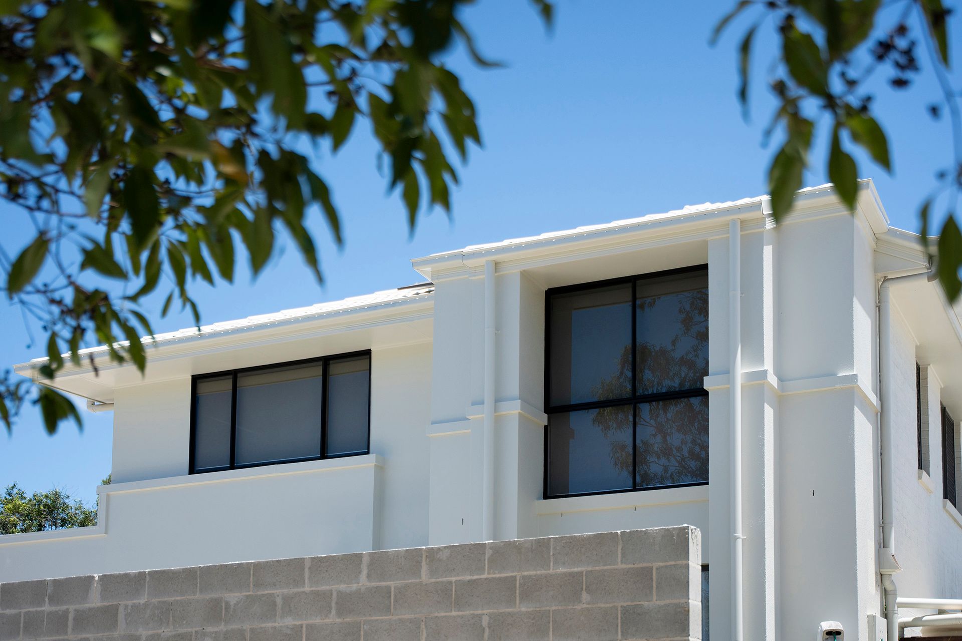 Modern White Two-story House With Dark Windows — Reynolds Built In Moffat Beach, QLD