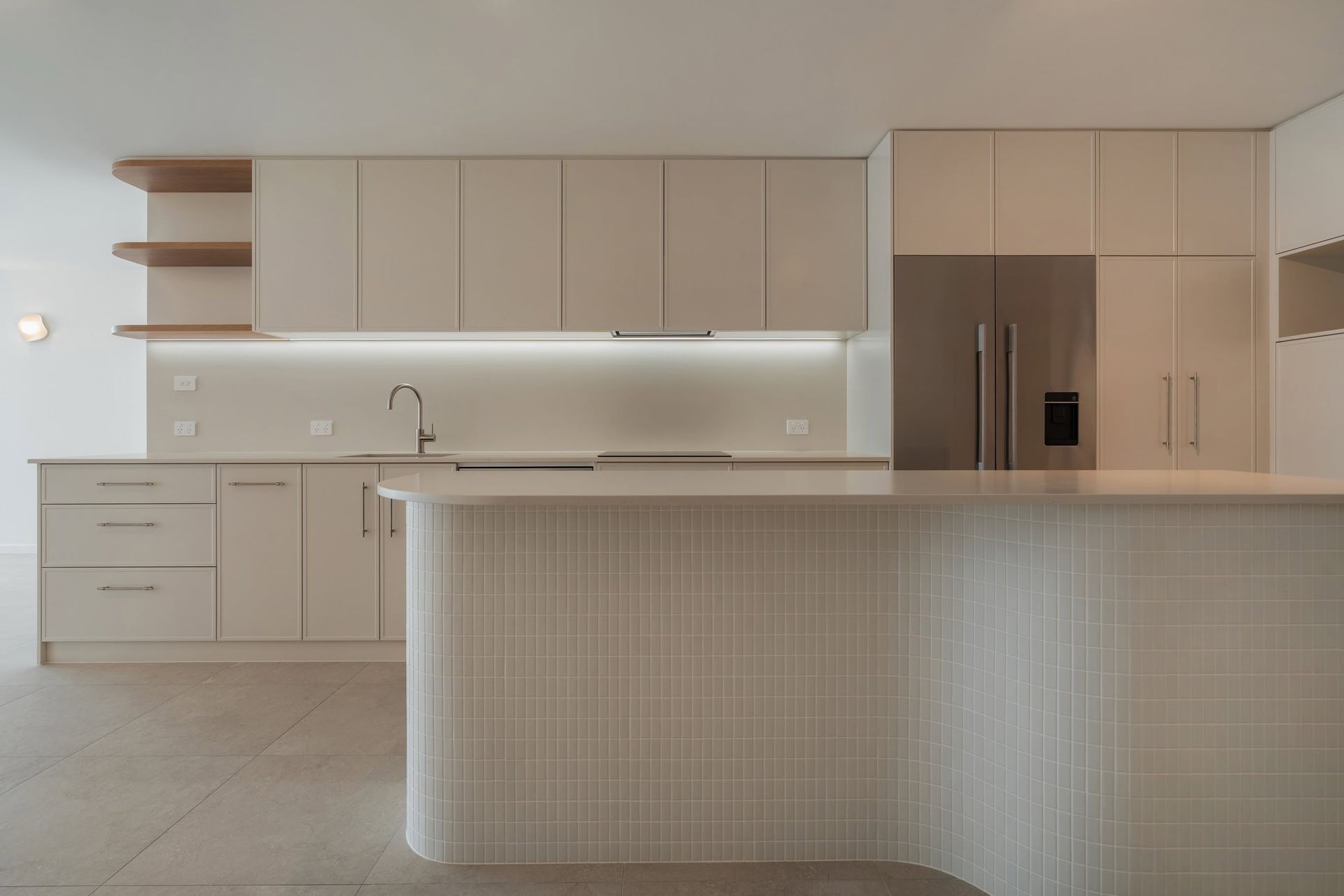 Minimal Modern Kitchen With Beige Cabinetry, Island, and Built-in Refrigerator — Reynolds Built In Moffat Beach, QLD