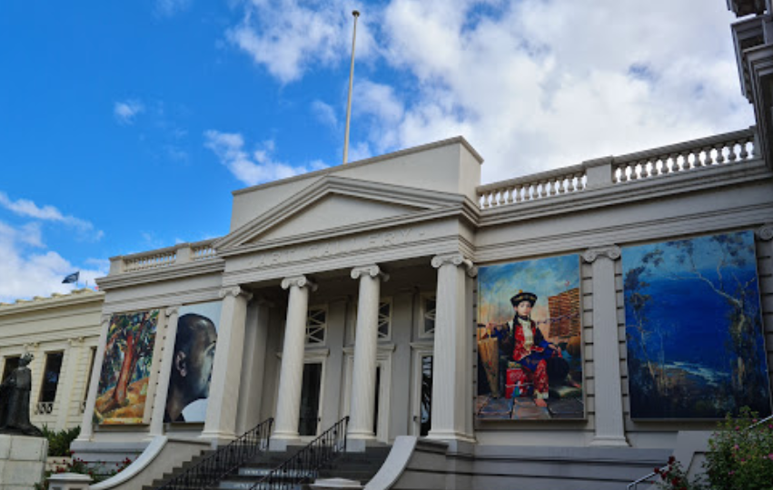 A large white building with paintings on the side of it