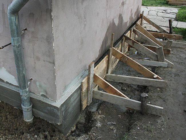 A wooden structure is being built on the side of a building