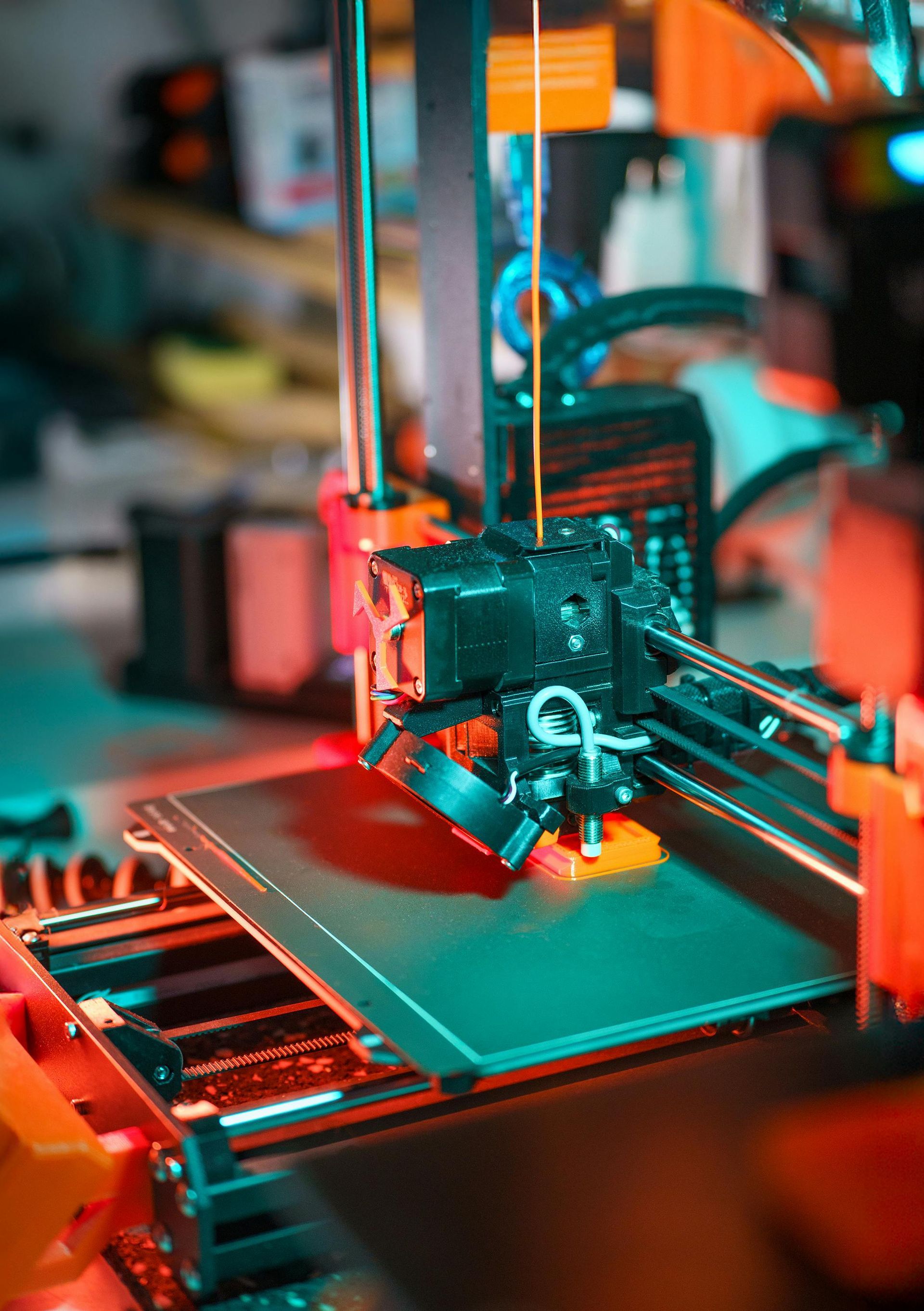 FDM 3D printer extruding a part on the build plate.
