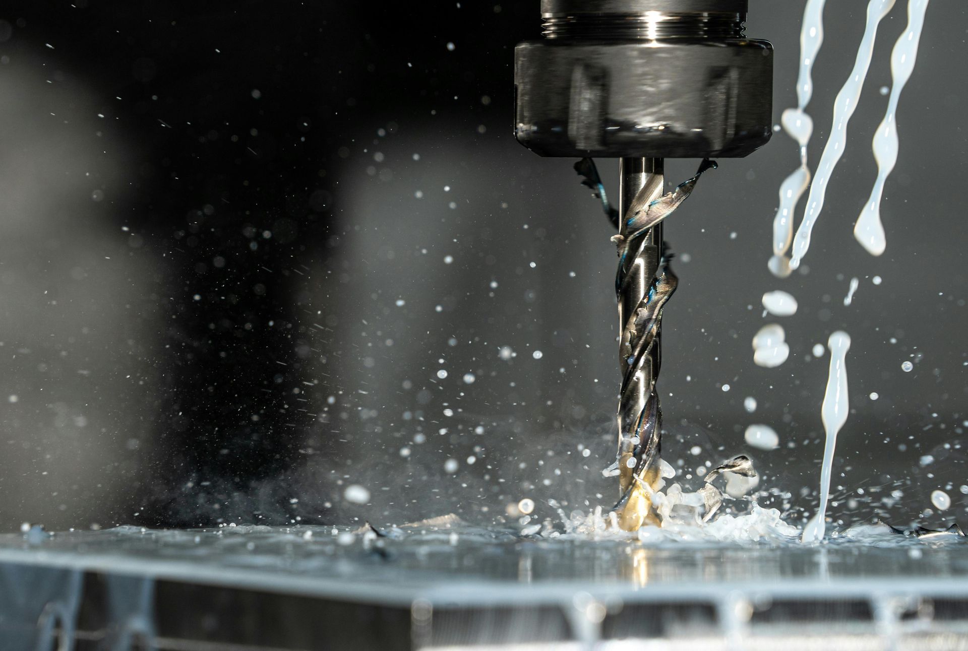 End mill cutting metal with coolant spray.