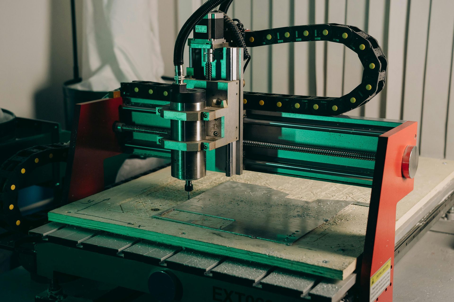 CNC router cutting a sheet on the workbed.