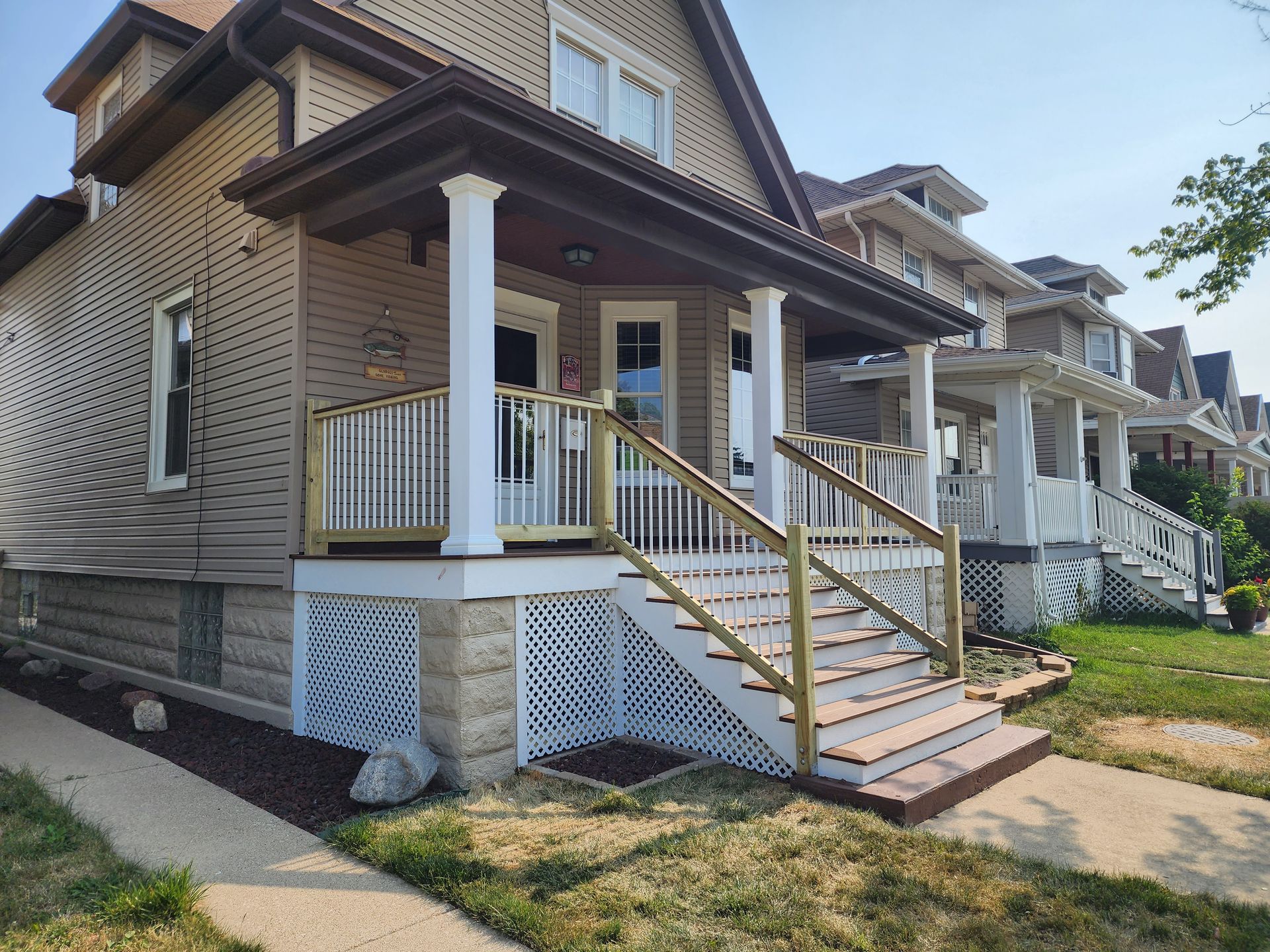 A house with a porch and stairs leading up to it.