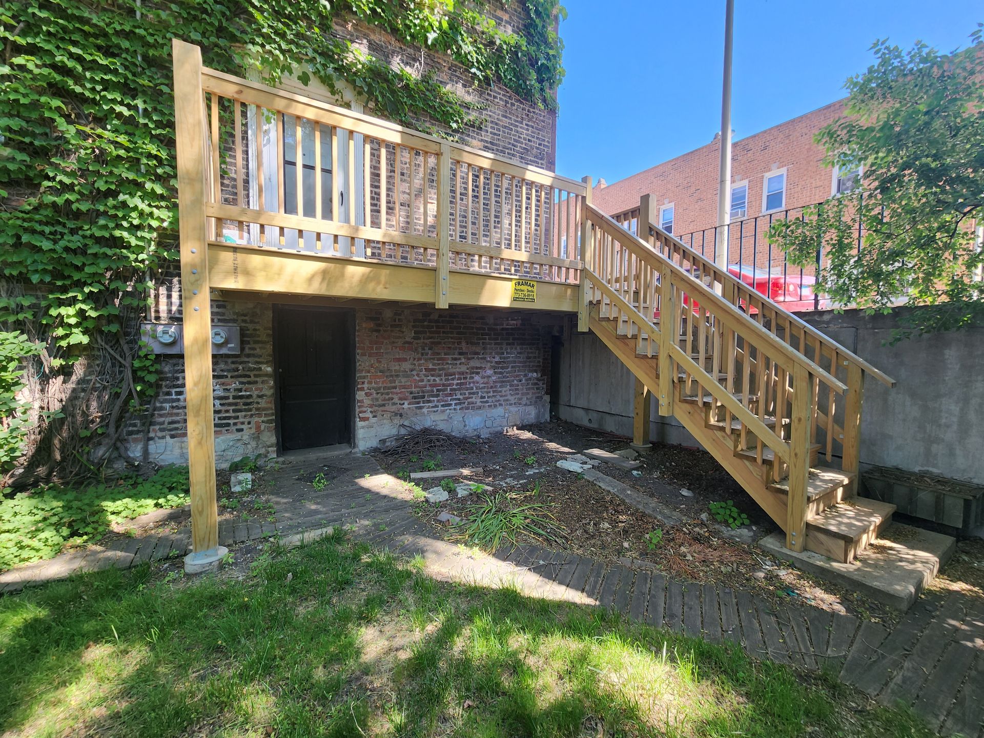 There is a wooden deck with stairs leading up to it.