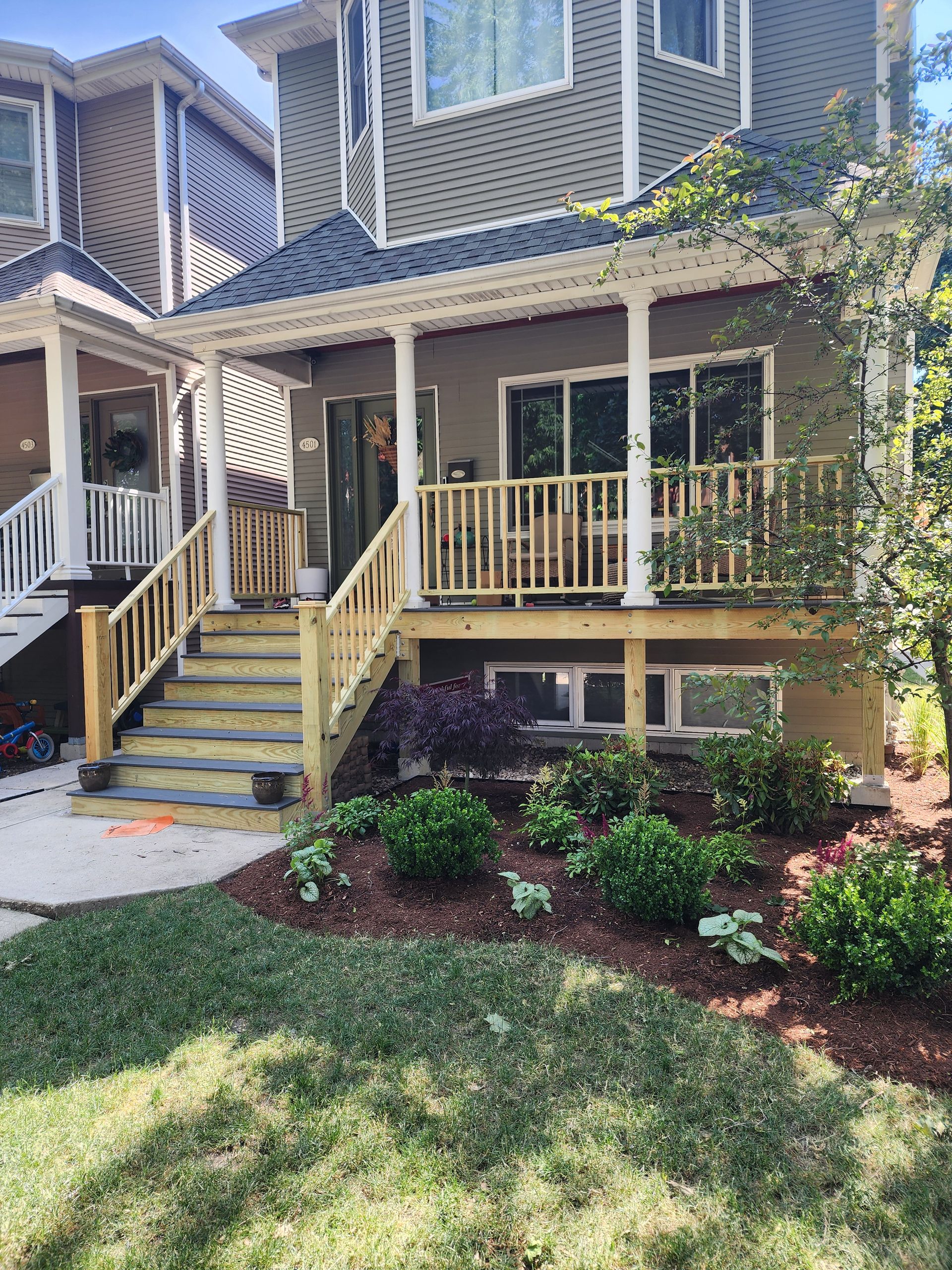 A house with a large porch and stairs leading up to it.