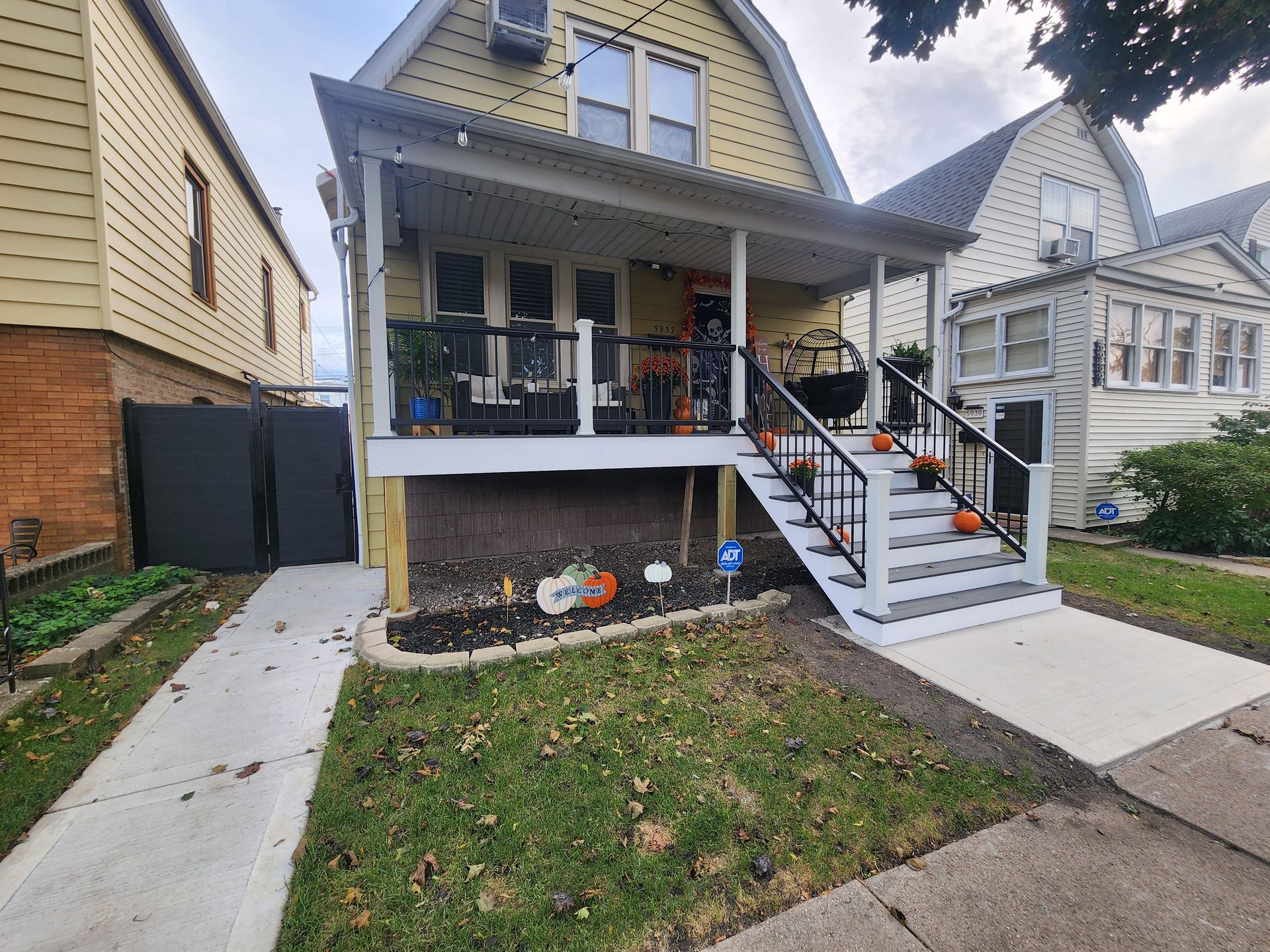 A house with a porch and stairs in front of it.