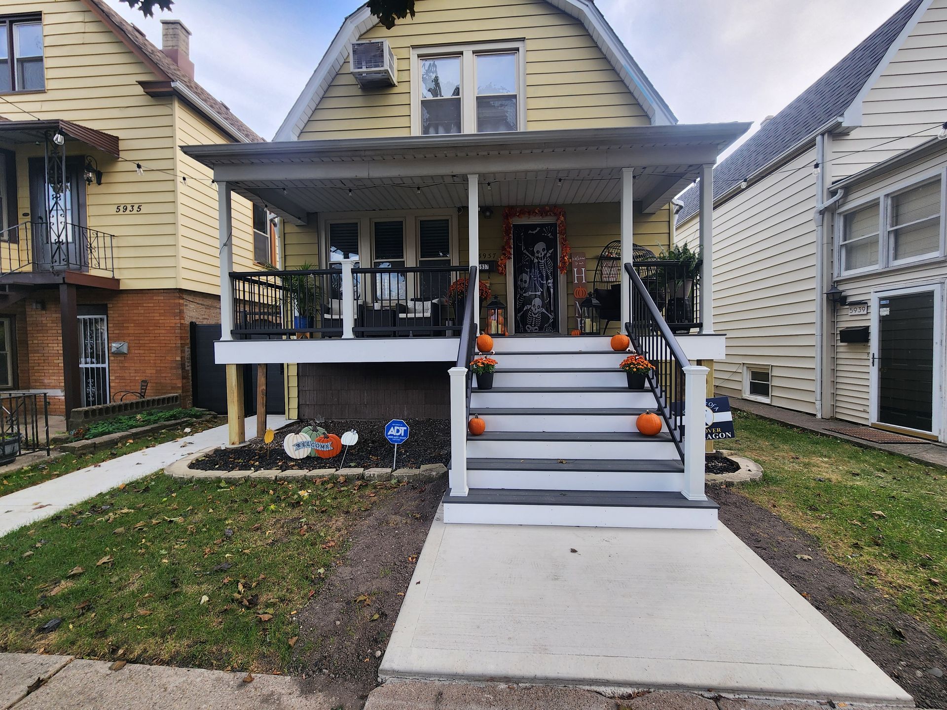 A house with a porch and stairs decorated for Halloween.
