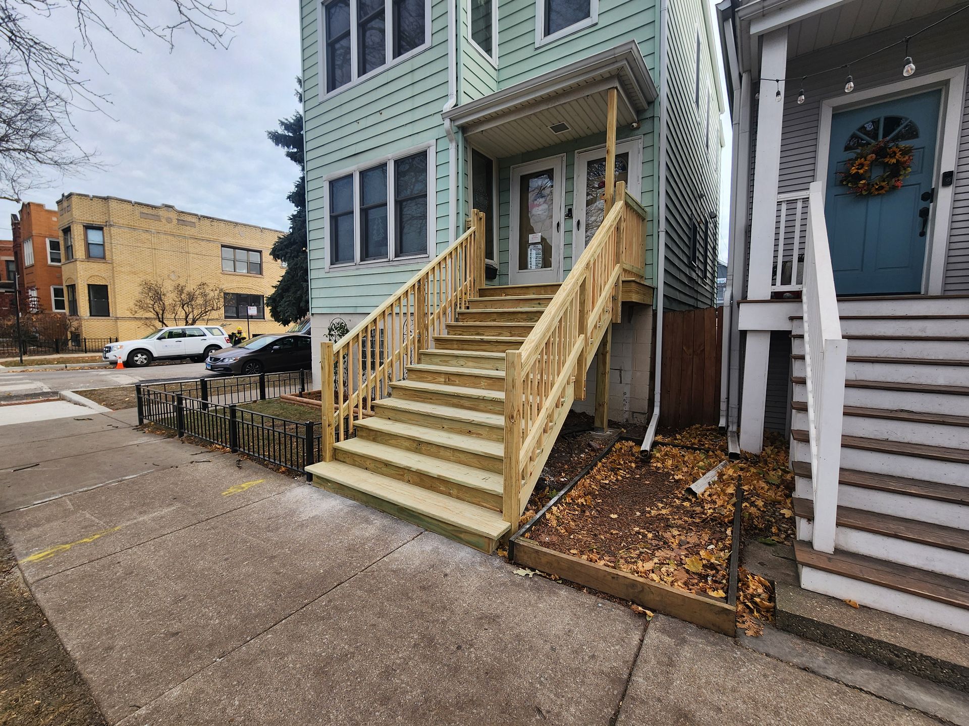 A house with wooden stairs leading up to the front door.