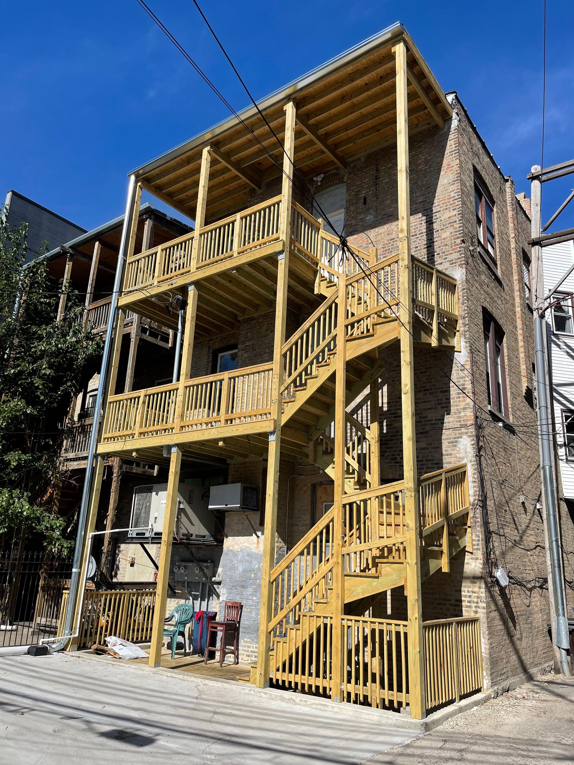 A building with wooden stairs on the side of it.