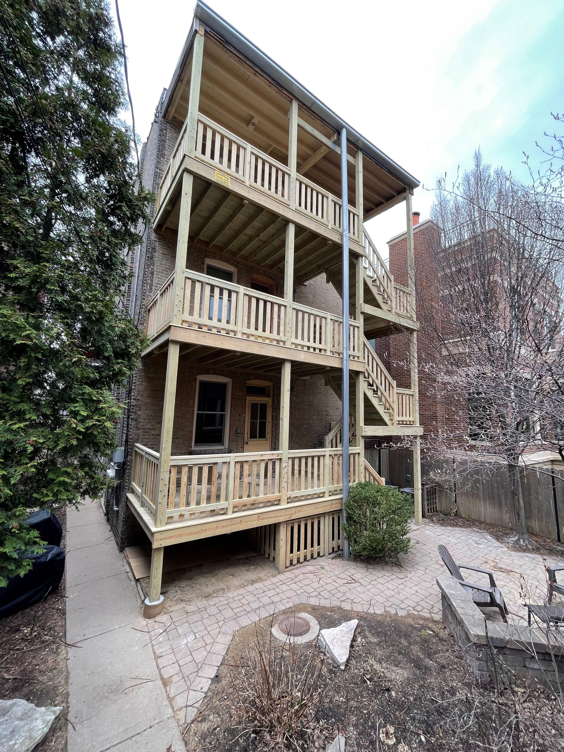 A large wooden house with a lot of balconies and stairs.