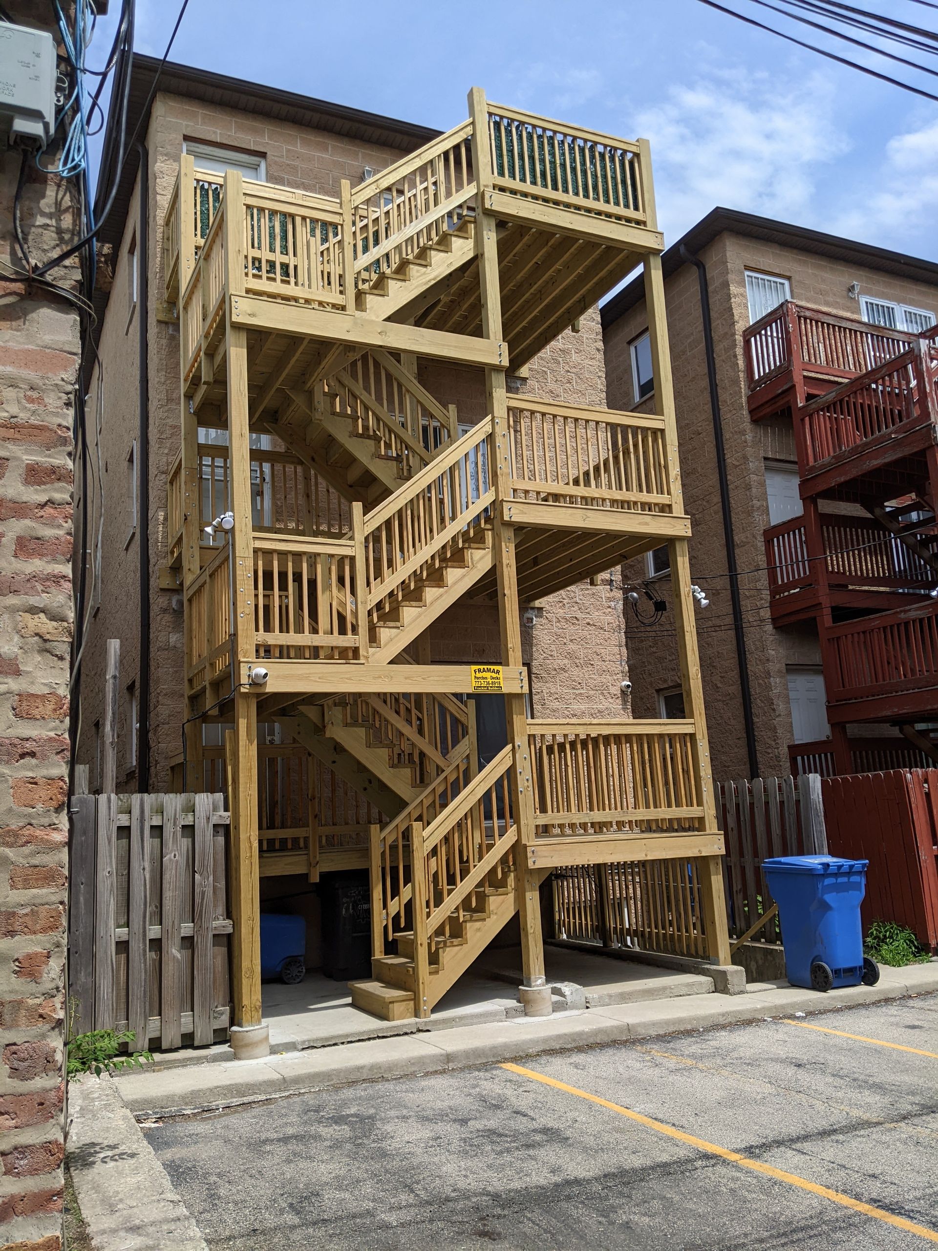 A wooden fire escape is built into the side of a building.