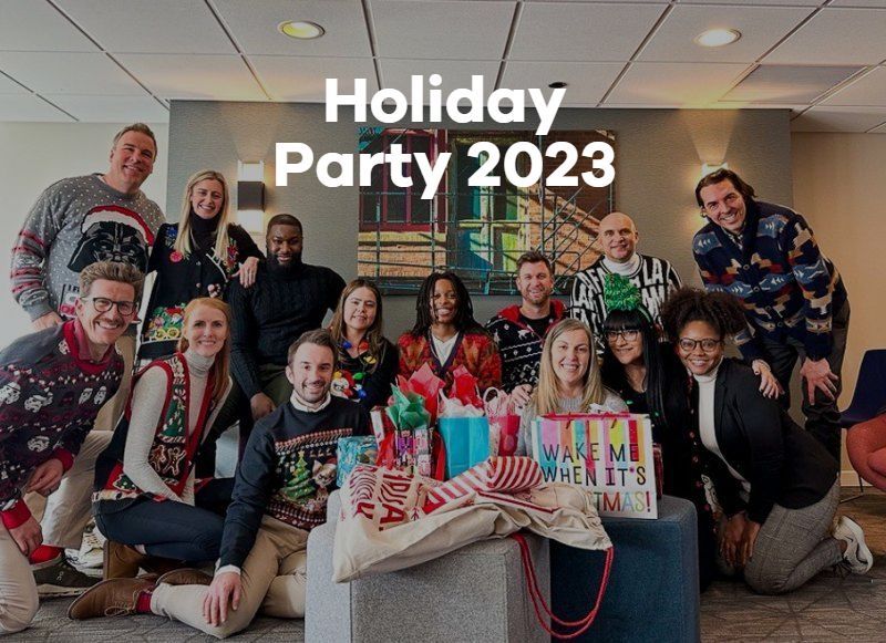 Group celebrating a holiday party indoors, posing with wrapped gifts and festive sweaters, with “Holiday Party 2023” text.