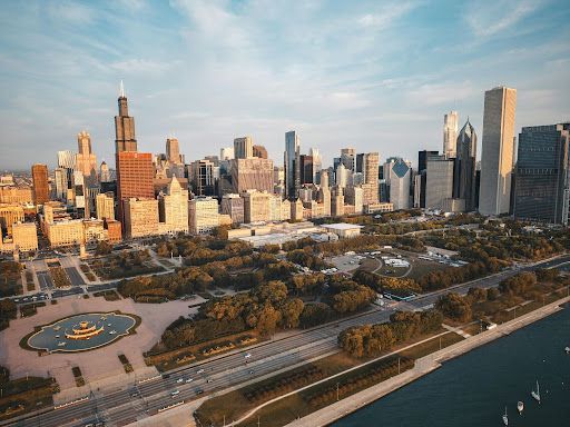 Chicago skyline and waterfront park at sunset, with Lake Michigan in the foreground