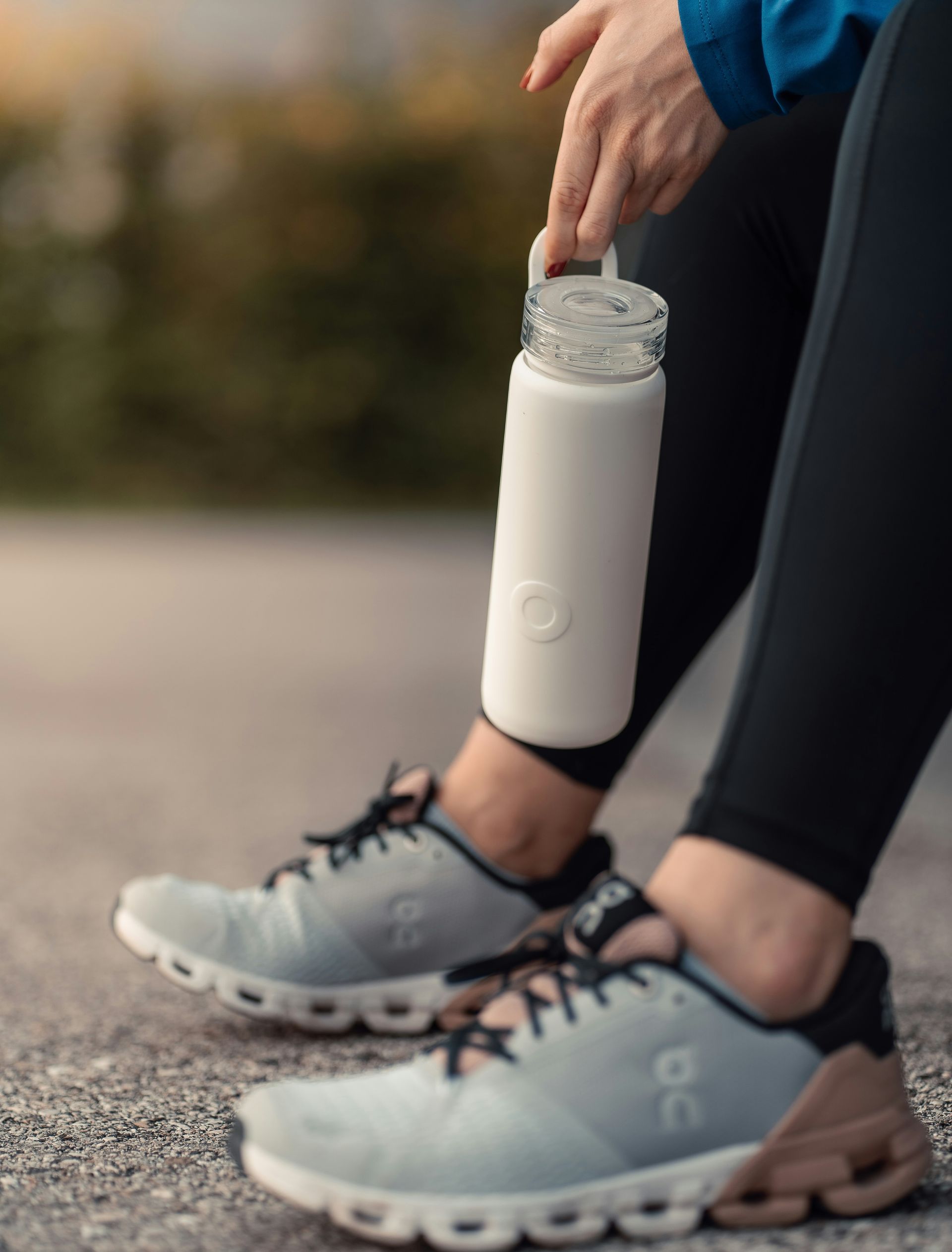 a person is resting and holding a water bottle.