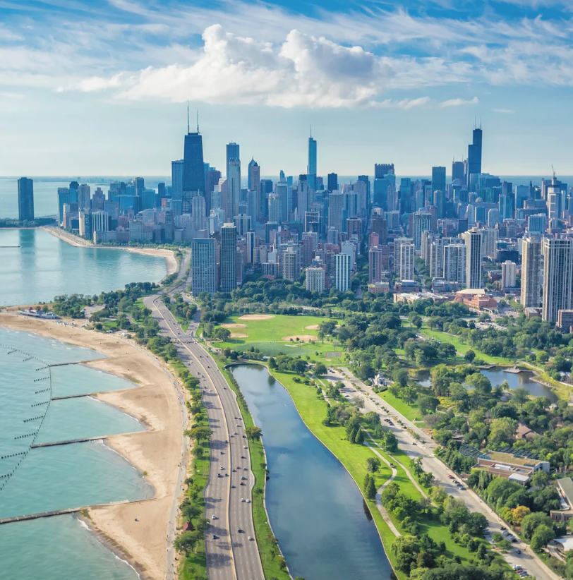 Chicago skyline along Lake Michigan. Buildings and highway adjacent to park.