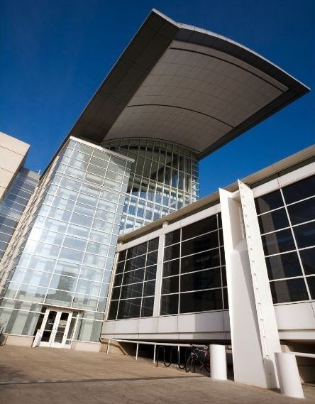 A large building with a curved roof and lots of windows