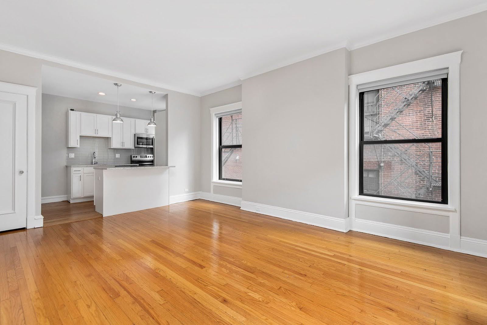 apartment photo showing kichen, wood flors and open layout