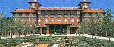 A large brick building with a red tile roof