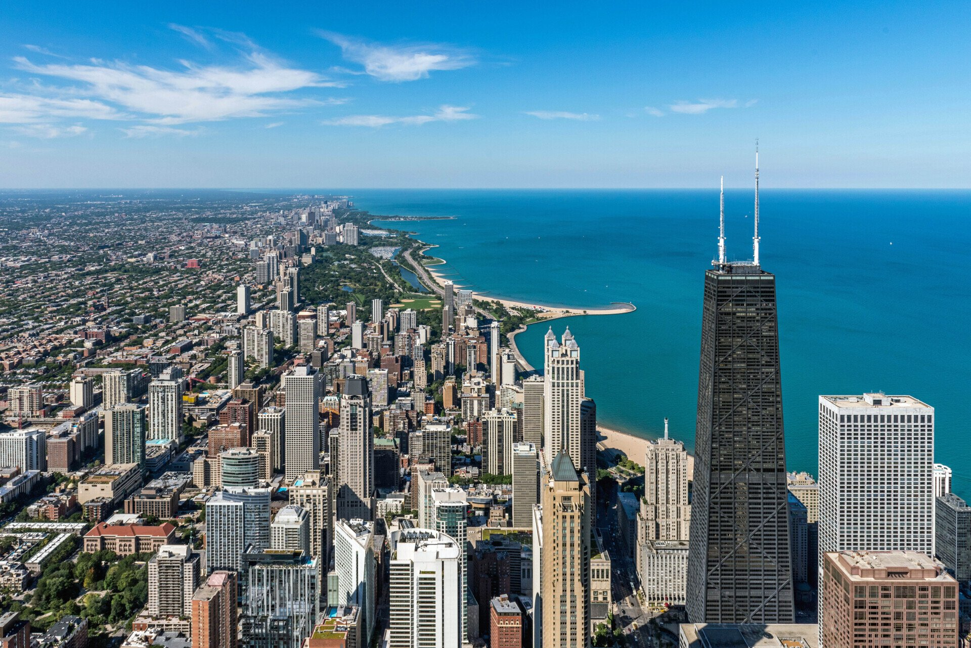 Chicago skyline and Lake Michigan shoreline on a clear day, with the John Hancock Center in the foreground