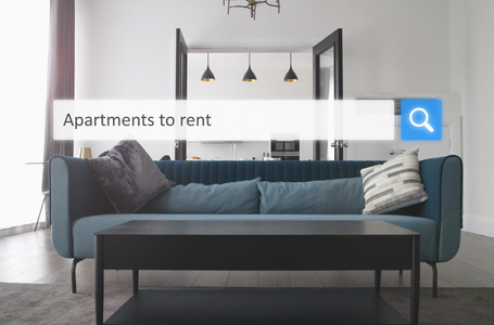 Living room with blue sofa and search bar reading “Apartments to rent”