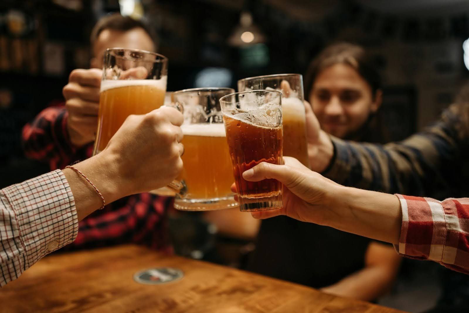 people clinking beers together