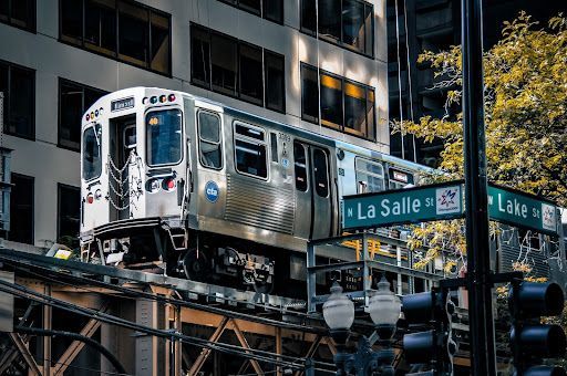 A train crossing the city on high-up rails between La Salle and Lake Street.