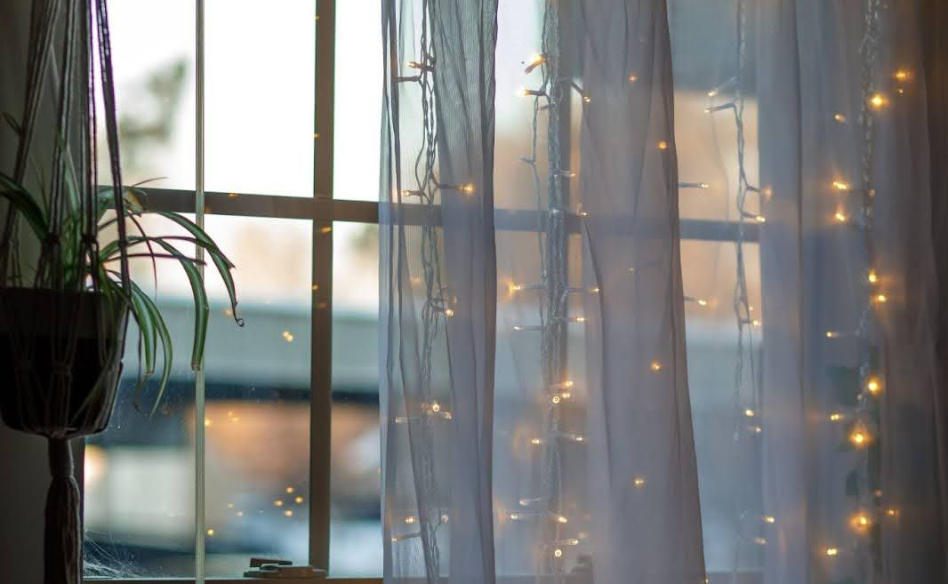 window with curtain and string lights