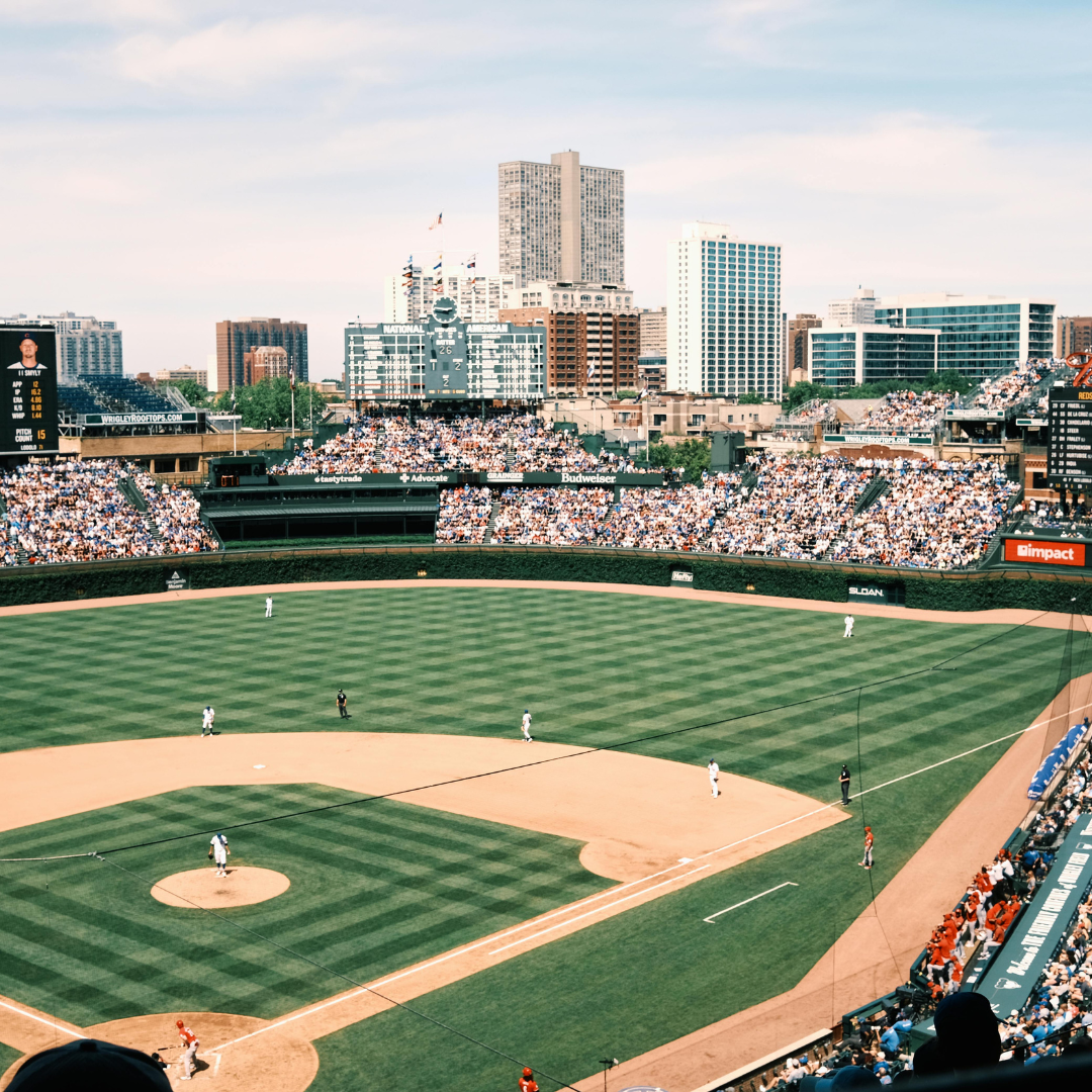 An aerial view of a baseball field with a city in the background in Chicago at Wrigleyville.