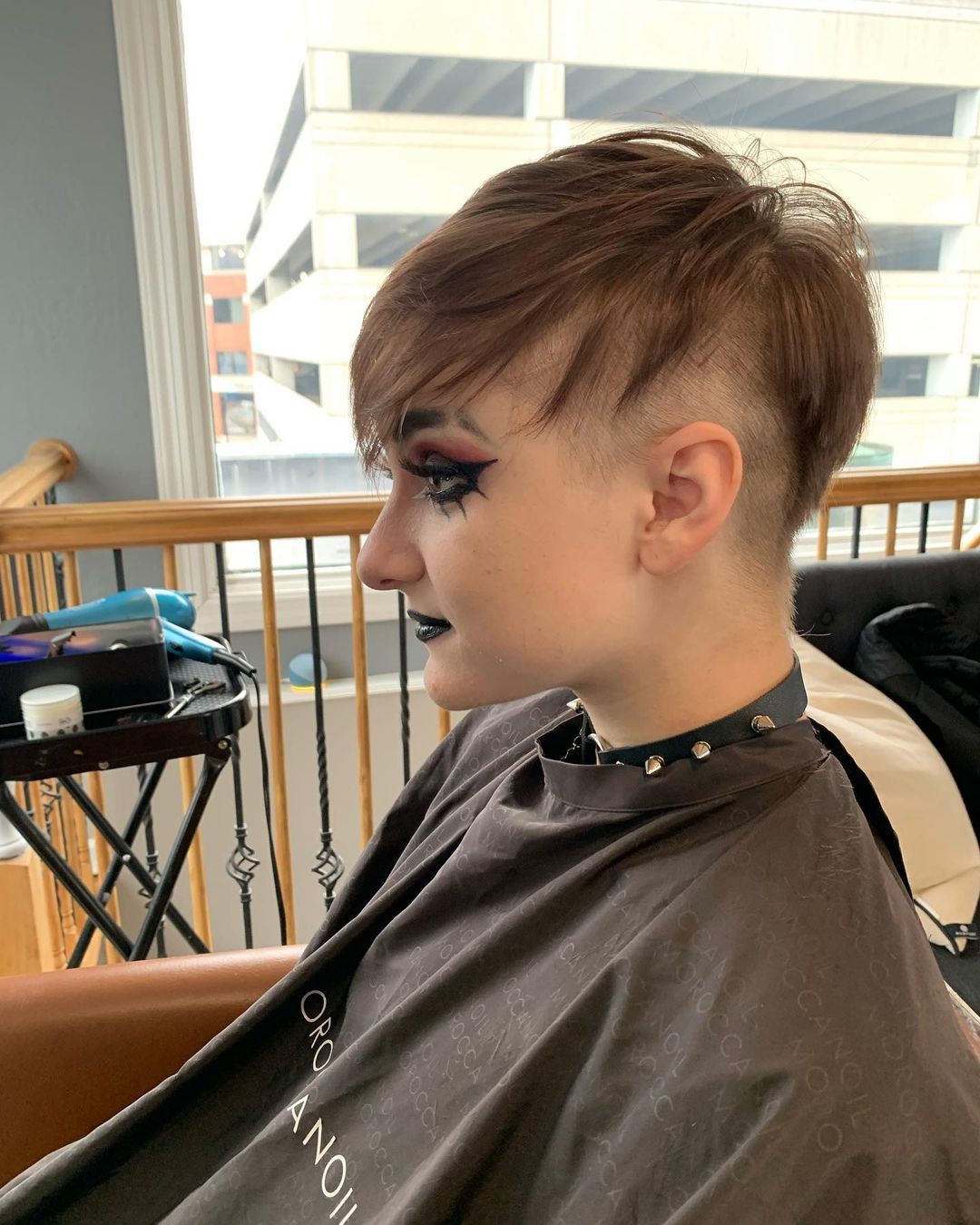 a person wearing a cape in side view