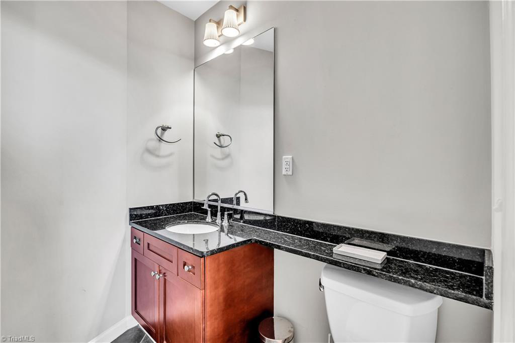 A bathroom with a sink , toilet and mirror