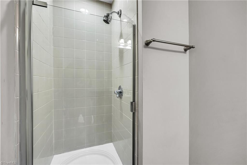 A bathroom with a walk in shower and a bathtub.
