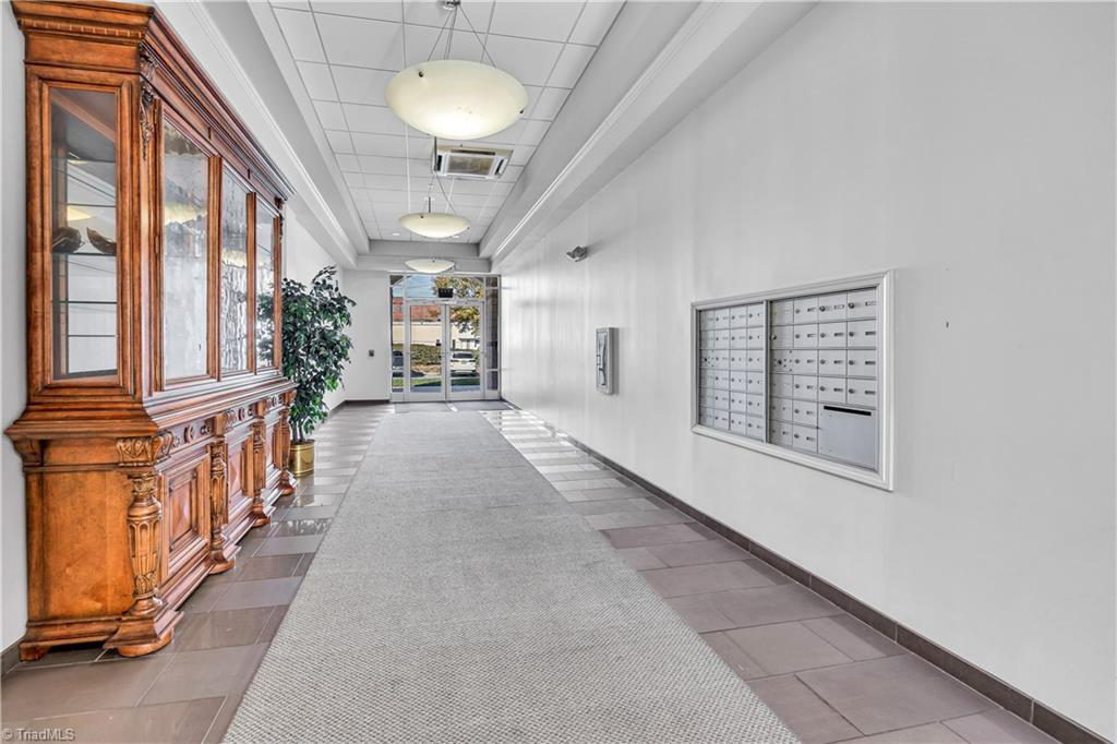 A long hallway with a large clock on the wall