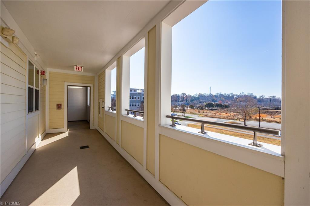 A long hallway in a building with a lot of windows
