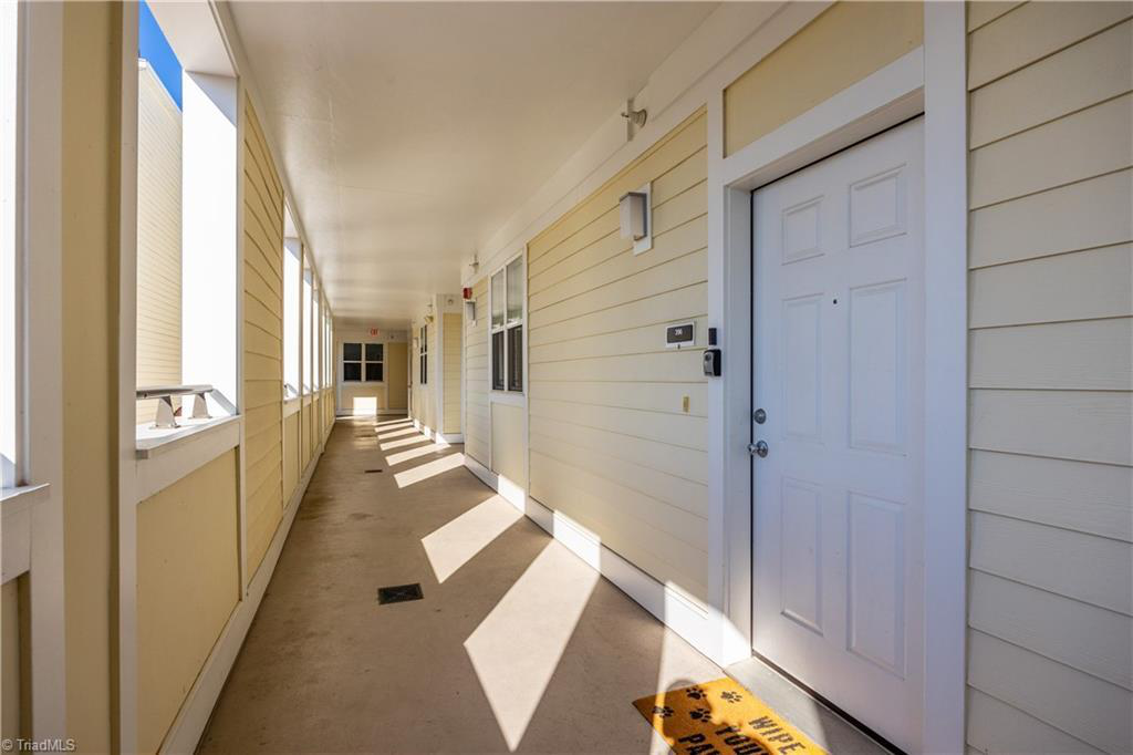 A hallway with a welcome mat on the floor