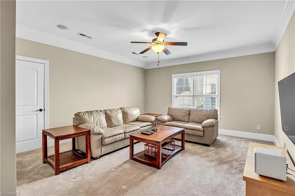 A living room with a couch , coffee table , and television.
