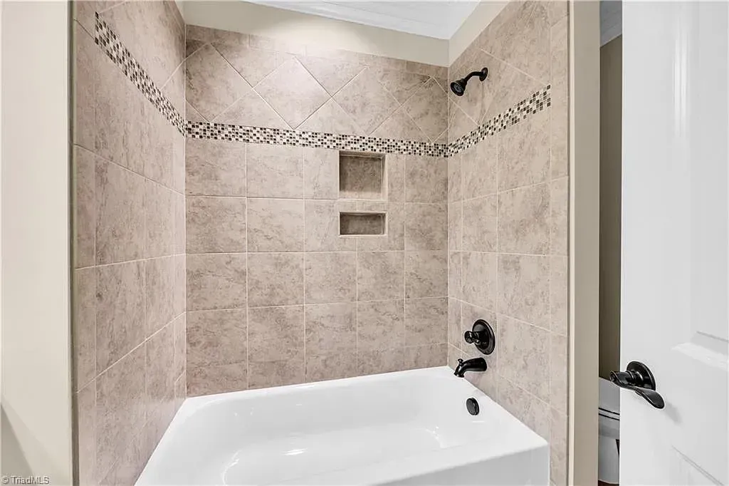 A bathroom with a bathtub and a shower.