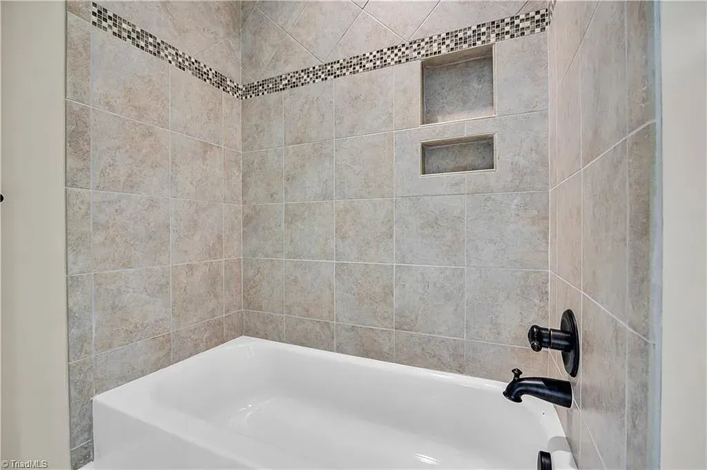 A bathroom with a bathtub and a shower.