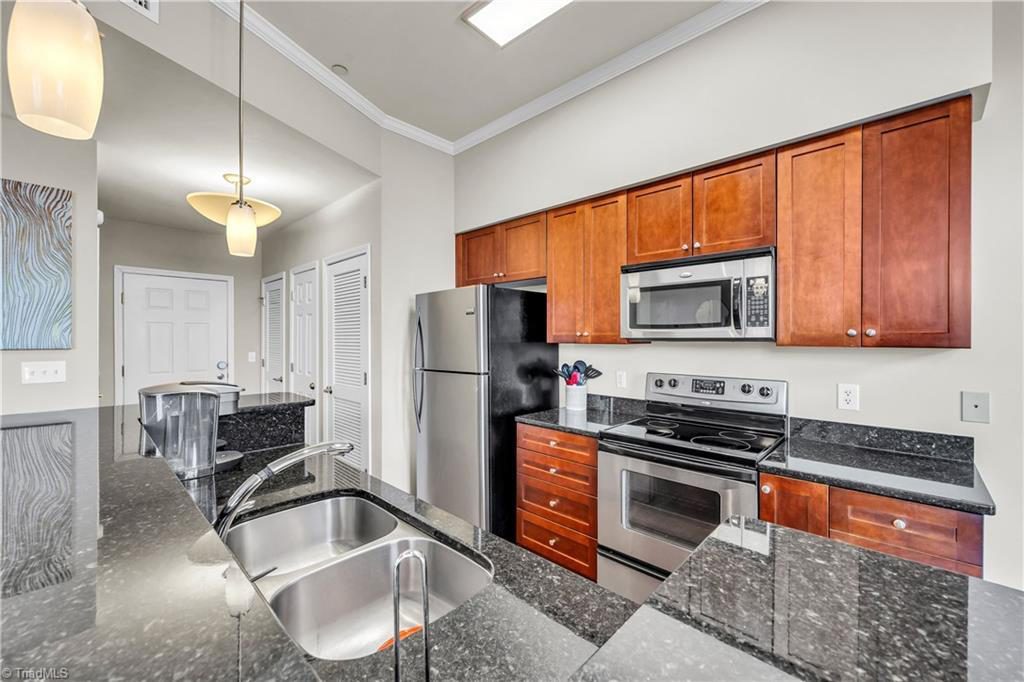 A kitchen with stainless steel appliances and granite counter tops
