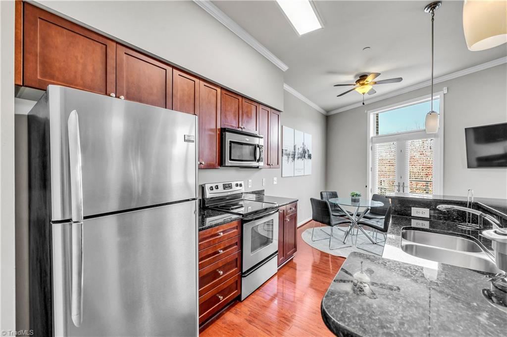 A kitchen with stainless steel appliances and wooden cabinets