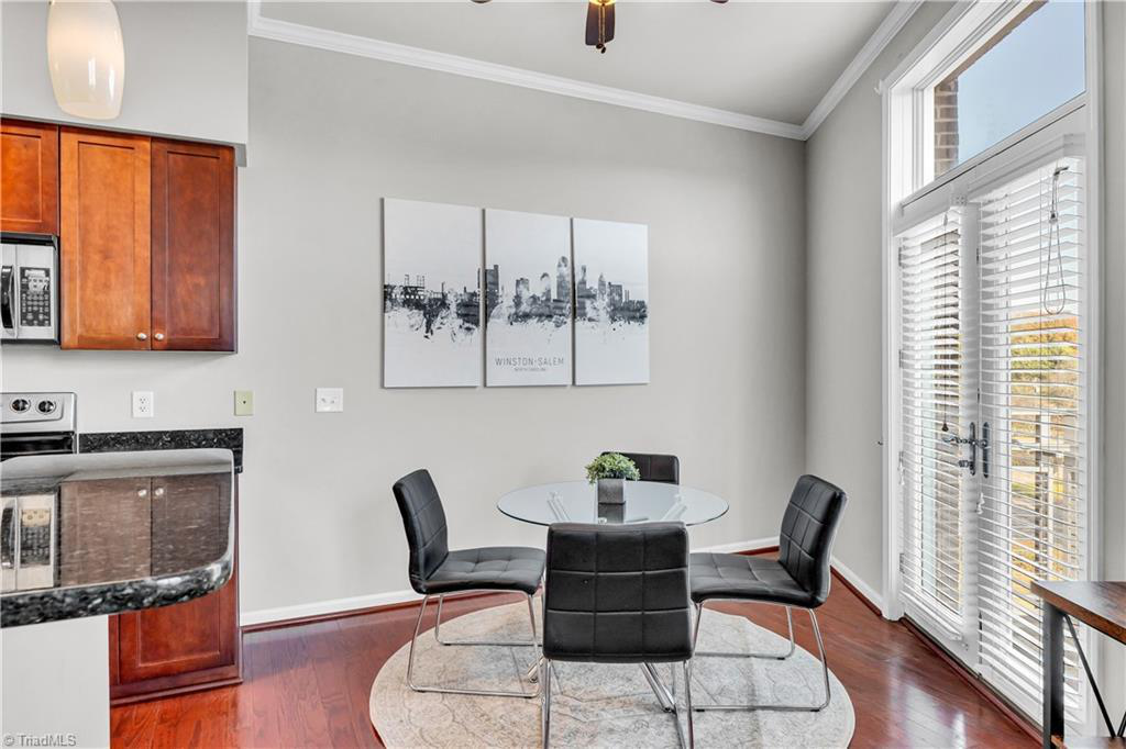 A dining room with a table and chairs in it