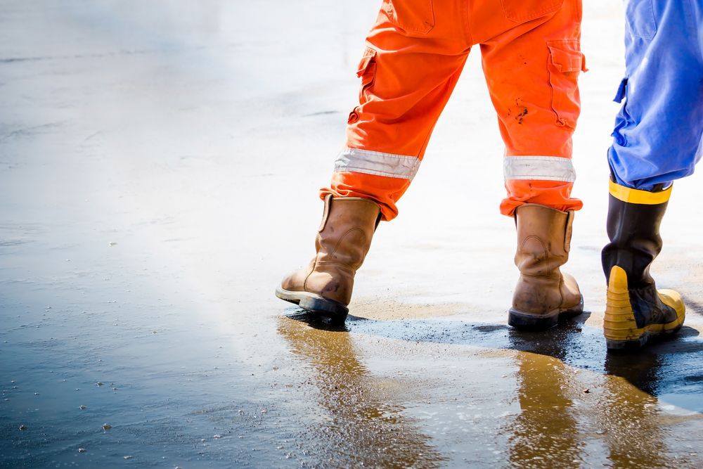 A Person Wearing Orange Pants And Brown Boots — Coffs Disposals, Workwear, Safety & Boot Centre in Coffs Harbour, NSW