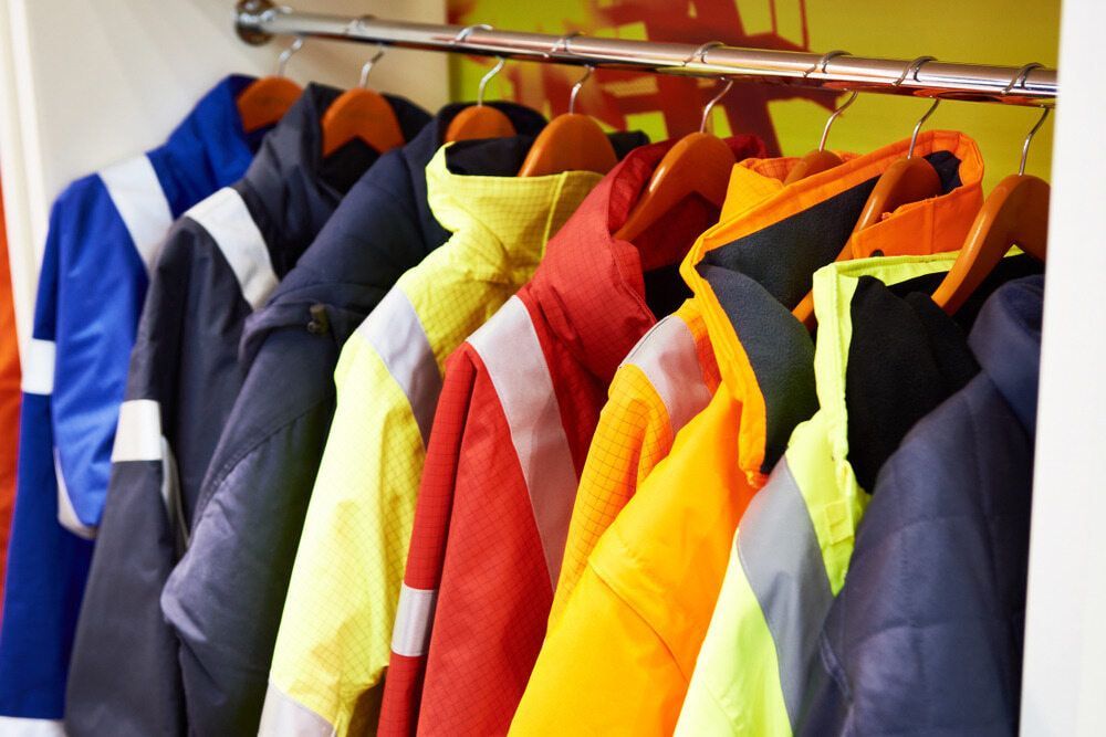 A Row Of Colourful Jackets — Coffs Disposals, Workwear, Safety & Boot Centre in Coffs Harbour, NSW