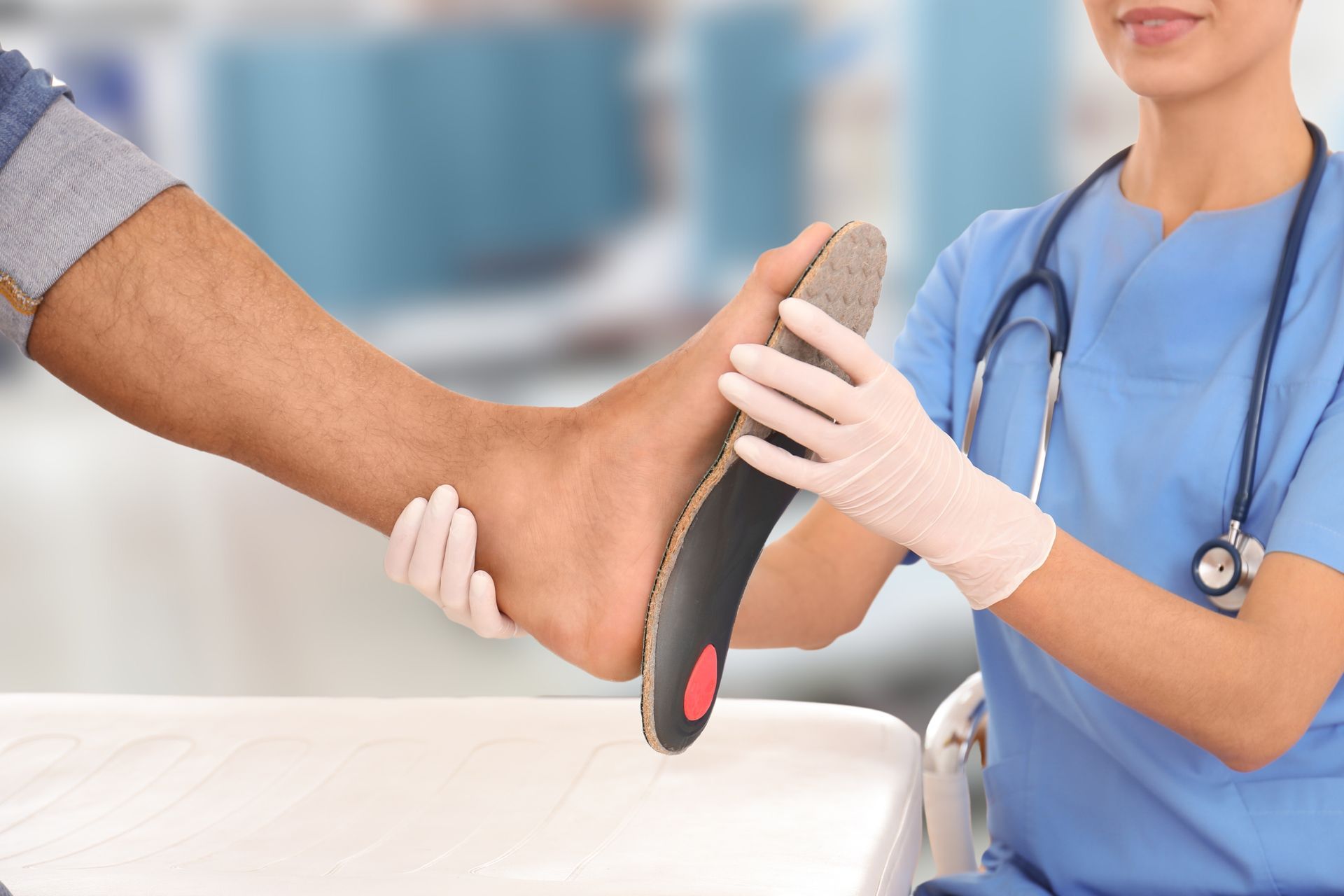 Nurse Examining a Patient's Foot With an Orthotic in a Medical Setting — Biomedical Sports Podiatry in Forster, NSW