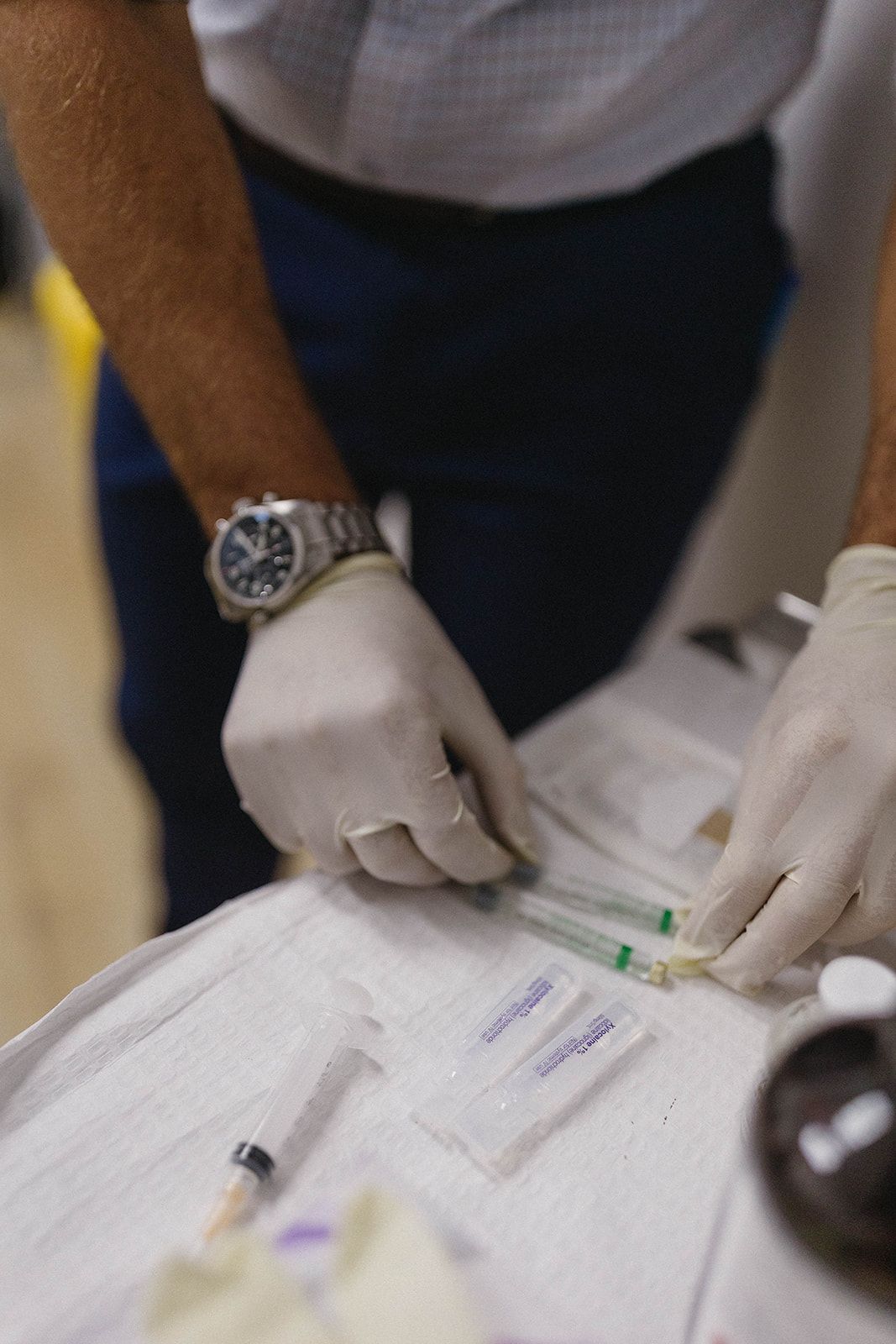 Person in Gloves Prepares Syringes on A Medical Tray — Biomedical Sports Podiatry in Forster, NSW