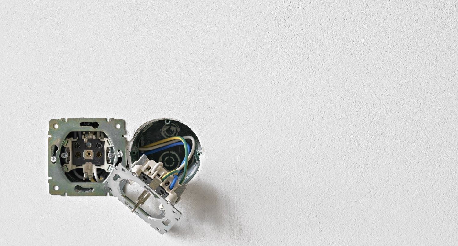 Small electronic device with exposed circuit board and wiring on a white background